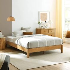 a bedroom with a bed, dresser and mirror