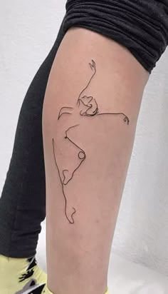 a woman's leg with a small tattoo on her left thigh and the outline of a tennis player