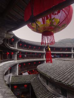 an overhead view of a building with red lanterns hanging from the ceiling and on the roof