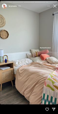 a bed sitting in a bedroom next to a wooden dresser and window with white curtains