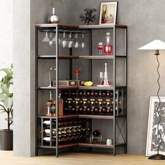 a wine rack with many bottles and glasses on it in a room next to a lamp