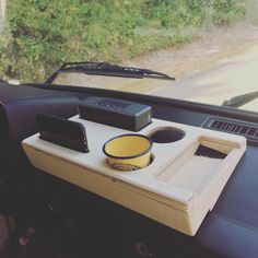 a car dashboard with a tray in the back seat and other items on top of it