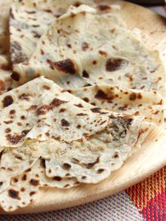 some tortillas are on a wooden plate