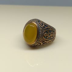 This empower ring is an awesome design bronze ring with an oval yellow Aqeeq. It is an awesome Masonic icon design bronze ring with a cabochon Yellow Aqeeq. It is an awesome design bronze ring. It has designed and made in Thailand. It is for the people who love to collect rare limited edition items and who wants to be different. This ring is one of a kind item for you. Material: Bronze The Main Stone: Yellow Aqeeq (Yellow Agate) Stone Color: Yellow Stone size: 10 x 14 mm. Ring weight approx.: 8 Bronze Oval Rings As Gifts, Bronze Oval Rings For Gift, Oval Bronze Rings For Gift, Yellow Agate, Bronze Ring, Yellow Stone, Ring For Men, Antique Design, Natural Blue Sapphire