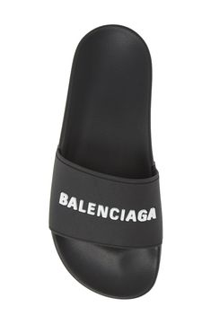 Welded logotype pops in texture and dimension from the bridge of an inky black sport slide molded with a contoured, comfortable footbed. Style Name:Balenciaga Logo Sport Slide (Women). Style Number: 5793907. Available in stores. Textured Sole Slides For Streetwear, Black Slides With Logo, Black Logo Slides, Comfortable Slides With Textured Sole For Streetwear, Modern Slides With Branded Insole For Streetwear, Leather Slides For Streetwear, Sporty Leather Slides For Streetwear, Modern Slides For Spring Streetwear, Classic Synthetic Slides With Branded Insole