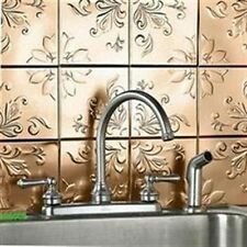 a kitchen sink sitting under a faucet next to a metal tile backsplash