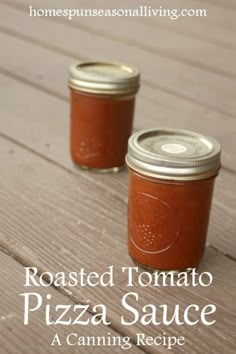 two mason jars filled with roasted tomato pizza sauce sitting on top of a wooden table