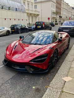 a red sports car is parked on the street