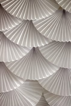 an abstract photo of white paper fan shapes