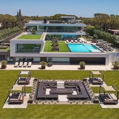 an aerial view of a house with a pool and lawn area in the foreground