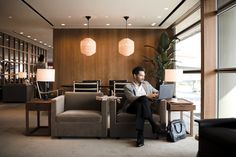 a man sitting on a couch using a laptop computer