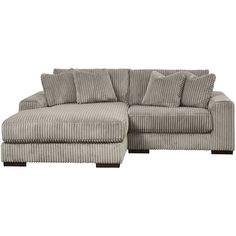 a gray couch with pillows on it and a footstool in the middle, sitting against a white background