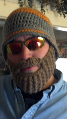 a bearded man wearing sunglasses and a knitted hat