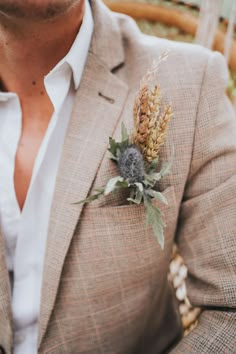 a man in a suit with a boutonniere on his lapel