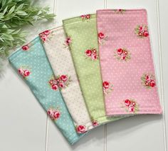 four napkins with roses and polka dots on them