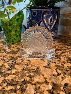 two glass vases sitting on top of a counter