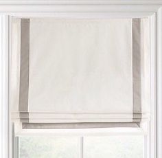 an open window with white curtains and blinds