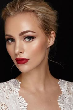 a woman wearing red lipstick and white dress