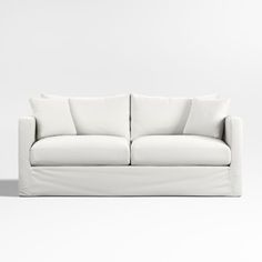 a white couch with three pillows on it