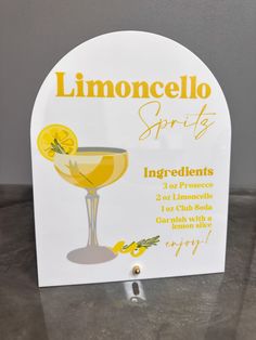 a sign advertising lemoncello spirits on the side of a table with an orange slice in it