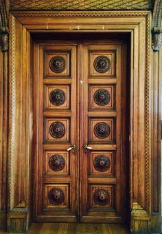 an ornate wooden door with decorative carvings on the front and side panels inlays