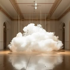 a large white cloud floating in an empty room