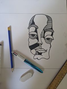 a drawing of a man's face is shown on a piece of paper