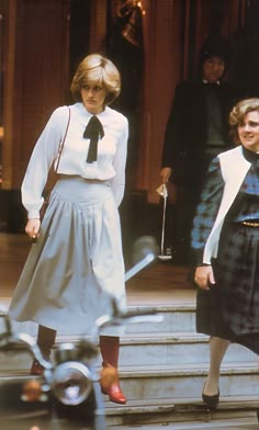 two women are walking down the steps together