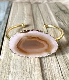 18k gold over brass, natural agate slice, gold dipped, open back. Gold Agate Bangle Bracelet, Gold Agate Bangle, Gold Agate Bangle Jewelry, Gold Agate Gemstone Bracelets, Elegant Gold Geodes With Natural Stones, Elegant Gold Agate Bracelet, Elegant Gold Agate Bracelets, Elegant Gold Geodes, Elegant Gold Geodes For Gift