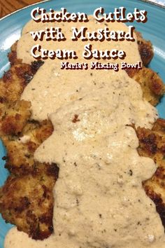 chicken cutlets with mustard and cream sauce on a blue plate