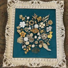 there are many different types of brooches in the picture on this wall hanging