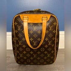 Authentic Louis Vuitton Excursion Travel Bag In Overall Great Condition. Exterior Is Monogram Canvas And Leather, Interior Is Pvc And Absolutely Pristine. Vachetta Is A Beautiful Honey Patina, Only Wear Is Some Darker Spots On The Handles And Scuffs On The Hardware, Please See All Pics. -Dust Bag Included -Lock & Key Included -Date Code: Mb0066 -One Interior Pocket -Made In France Measurements: W 9.4 X H 13.0 X D 5.1 " / Handle Drop 6.1 " Rectangular Monogram Canvas Luggage For Formal Use, Formal Monogram Canvas Rectangular Luggage, Formal Rectangular Monogram Canvas Luggage, Locks & Key, Leather Interior, Monogram Canvas, Authentic Louis Vuitton, Spot On, Brown Gold