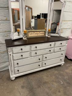 an old dresser with a mirror on top