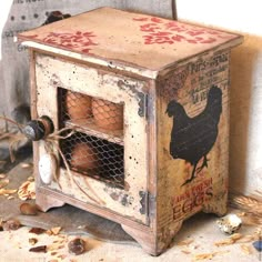 an old wooden box filled with eggs sitting on top of a floor next to a wall