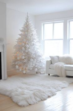 a white christmas tree in the corner of a living room with fluffy fur rugs