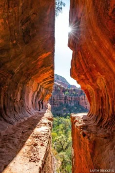 the sun shines through two narrow canyons