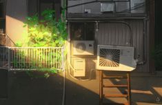 an air conditioner sitting on top of a wooden table next to a building with a green plant growing out of it