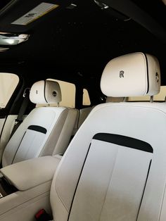 the interior of a car with white leather seats