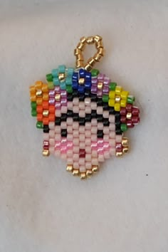 a beaded keychain with an evil face on it