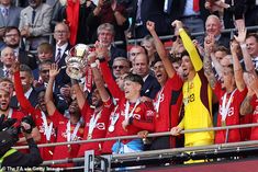 the liverpool united players are celebrating with their trophy