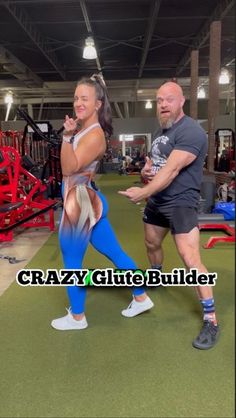 a man and woman doing squats in a gym