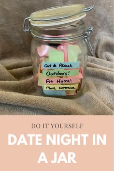 a jar filled with notes sitting on top of a bed