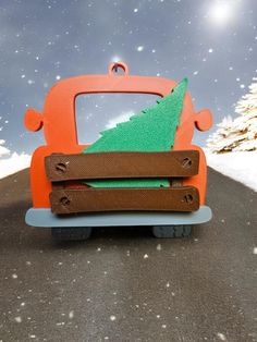 an orange car with a green christmas tree on it