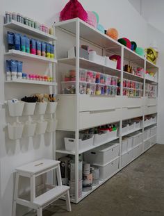 a room with shelves filled with craft supplies