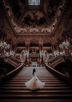 a woman in a white dress is sitting on some stairs