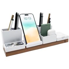 an iphone and pen holder on a wooden tray with two compartments for pens, pencils, and other office supplies