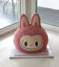 a pink stuffed animal sitting on top of a table