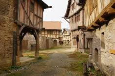 an alley way with old buildings in the background