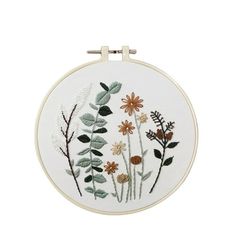 an embroidery kit with flowers and leaves on it