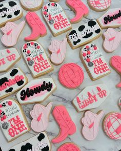 decorated cookies are displayed on a marble surface